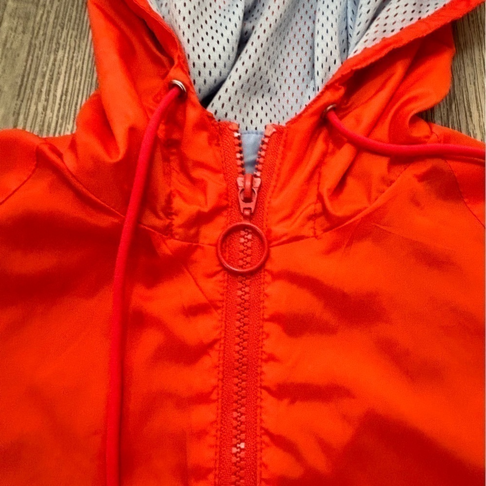 Lightweight women’s hooded jacket coat with drawstrings around bottom hem. - Picture 4 of 5